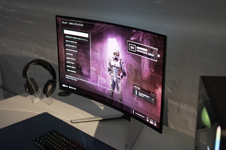 The Alienware 32 4K QD-OLED on a table with a game on the screen.