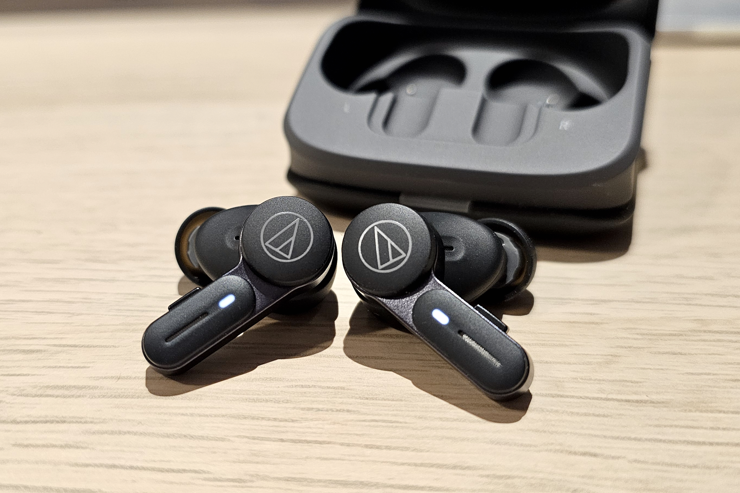 Audio-Technica ATH-TWX7, both earbuds in front of case.