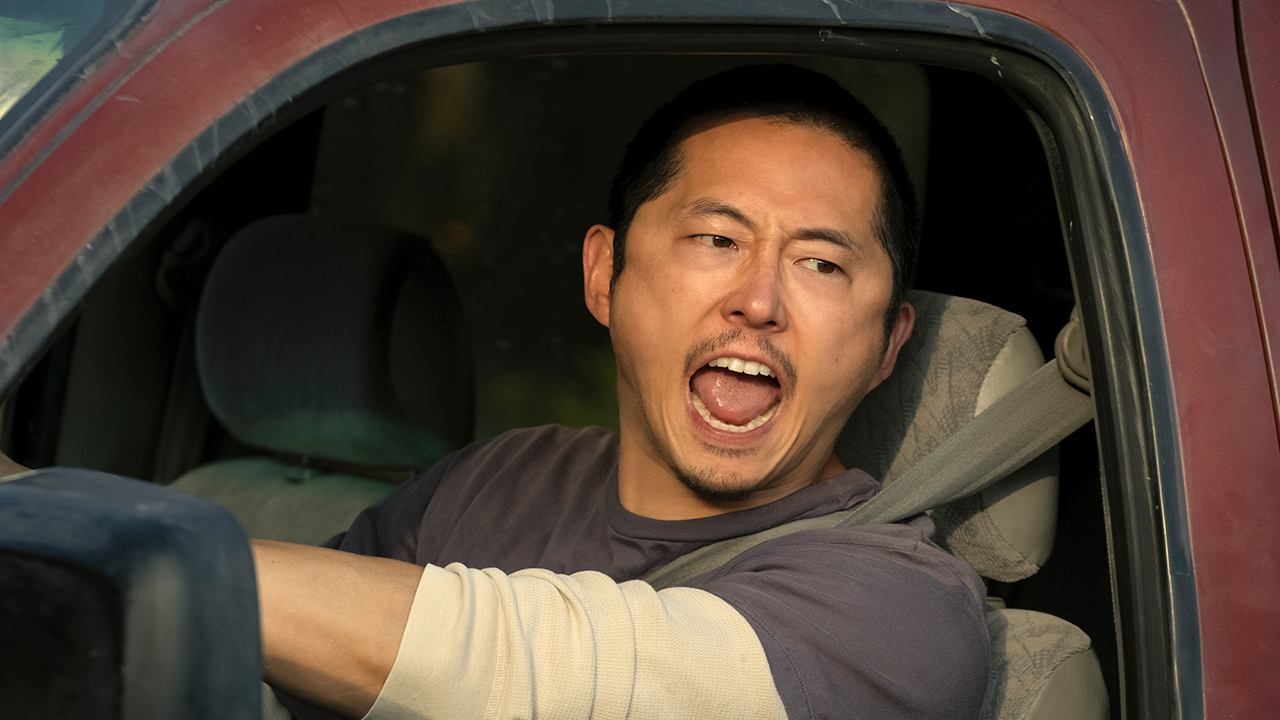 A man behind the wheel of a car yelling in a scene from Beef.