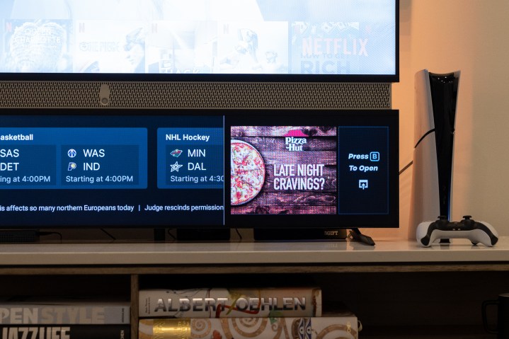 The secondary Smart Display on Telly shows advertising for Pizza Hut alongside sports scores.