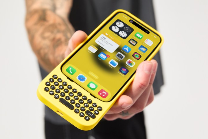 Someone holding the Clicks iPhone keyboard accessory.