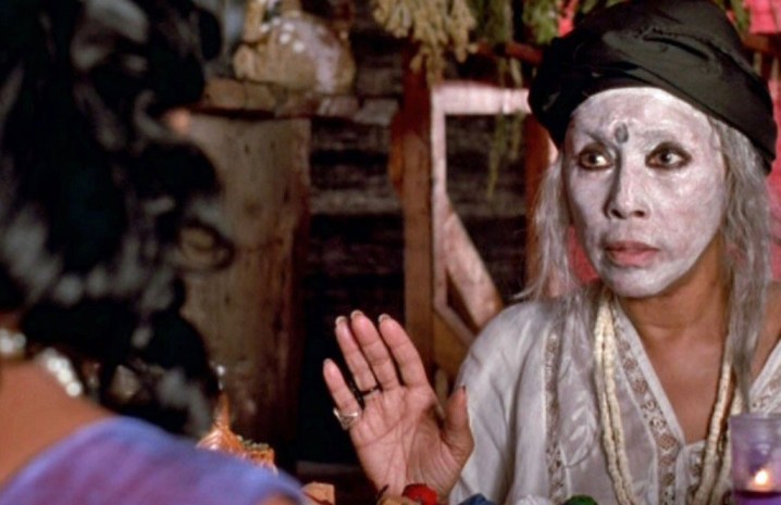 A woman wearing white makeup talks in Eve's Bayou.