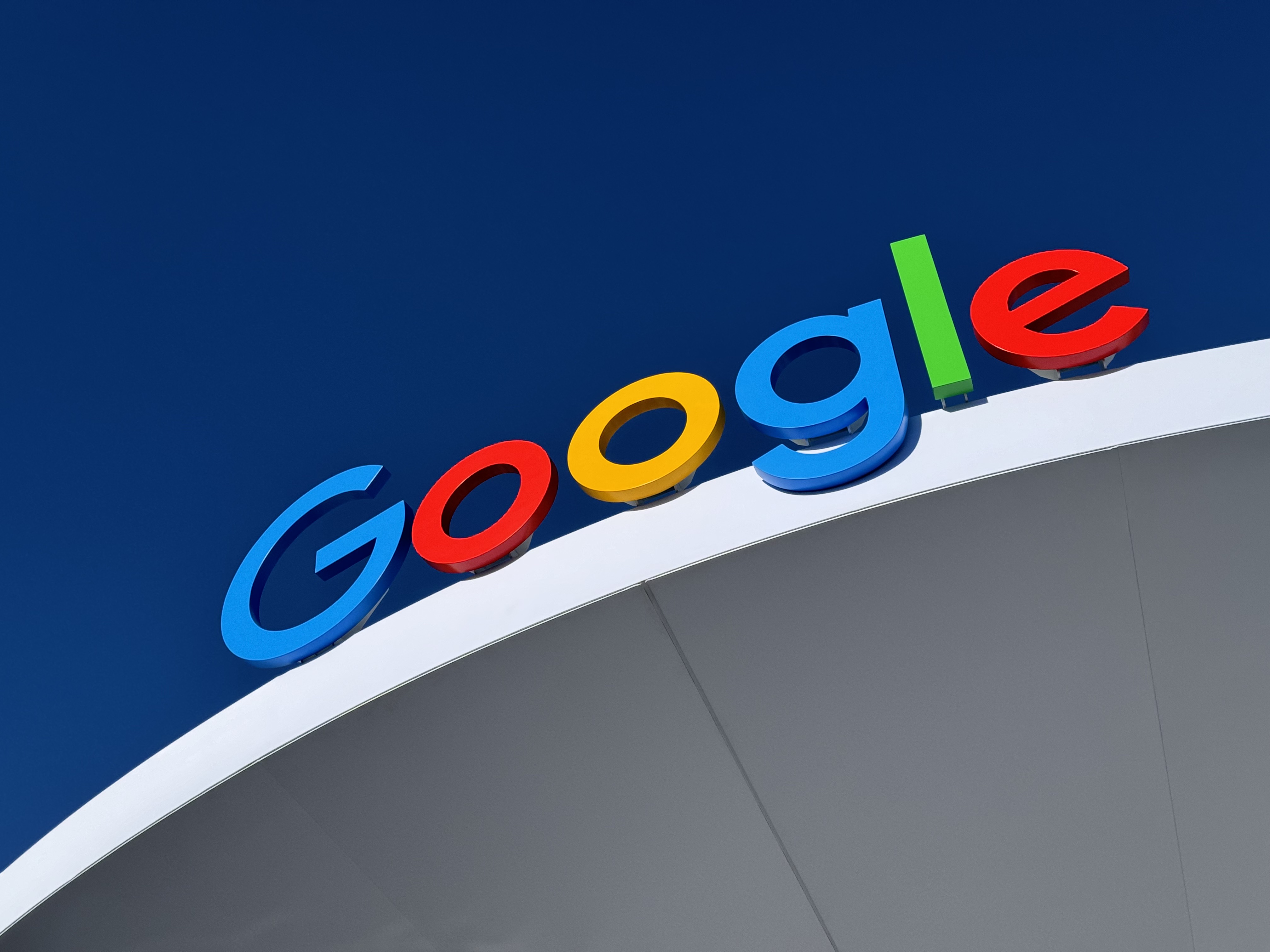 A Google logo sign at the top of a building.