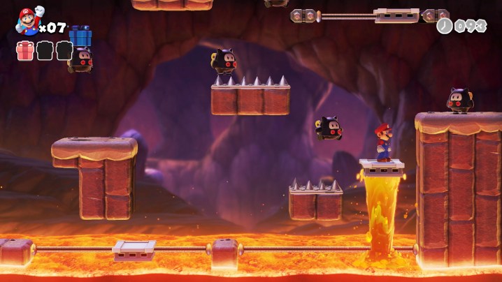 Mario jumps on a platform over lava in Mario vs. Donkey Kong.