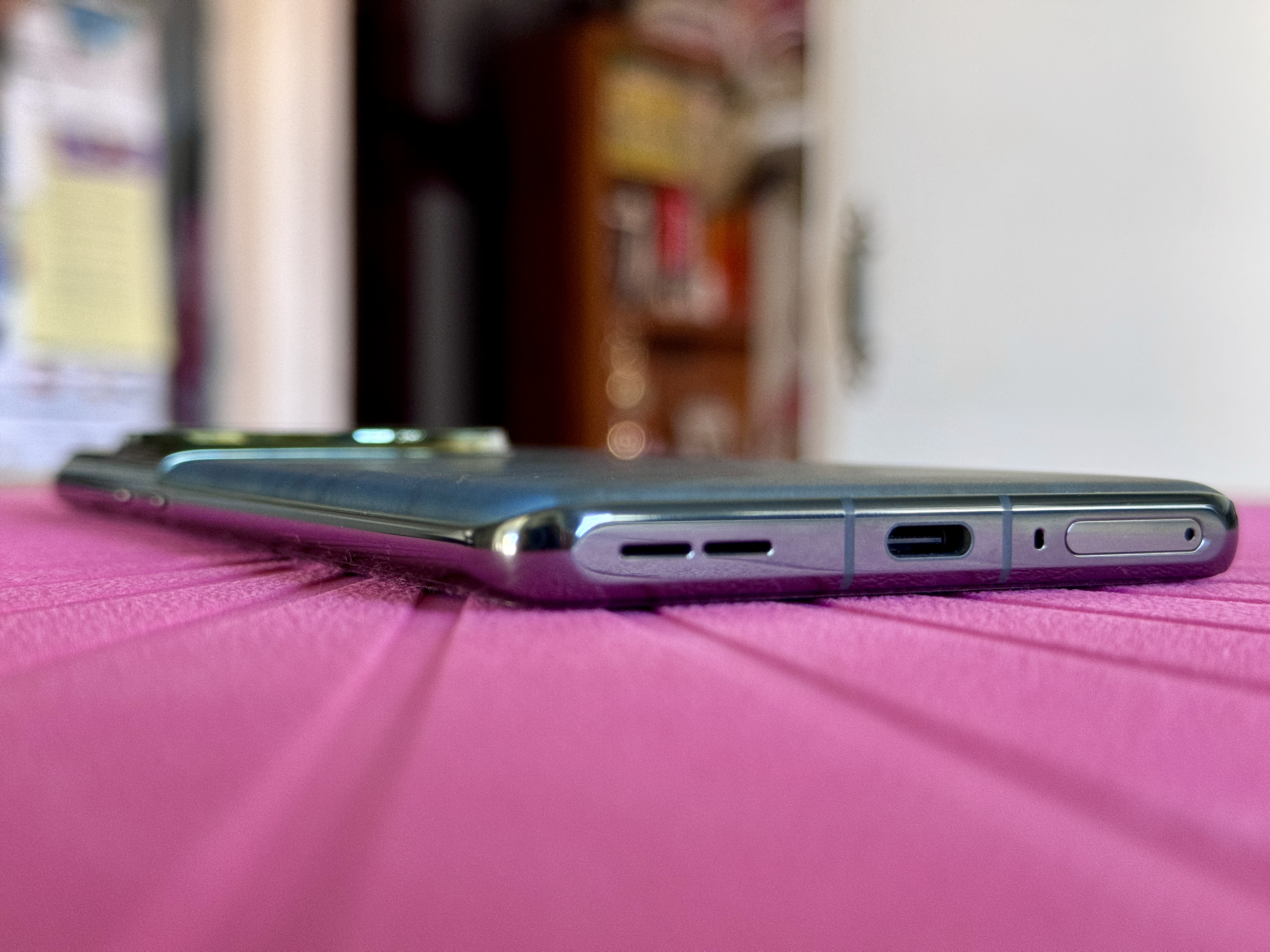 OnePlus 12 in Flowy Emerald showing flat bottom edge.