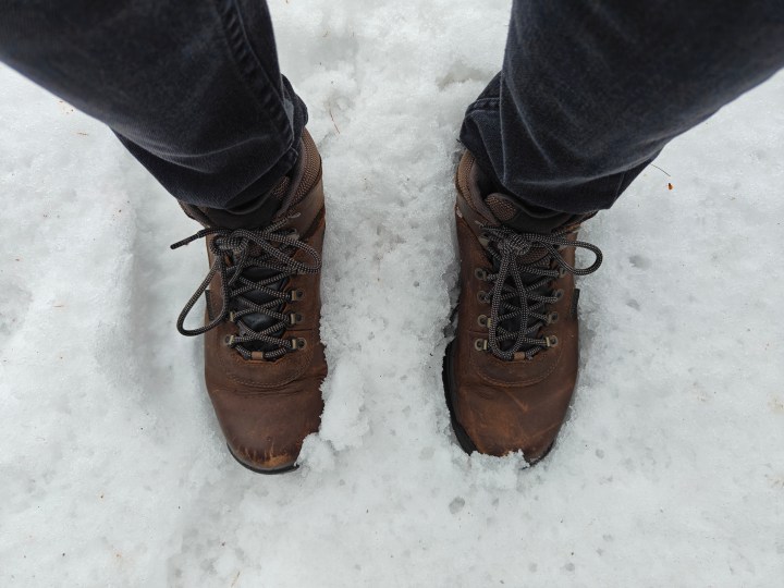 A photo of someone wearing brown boots standing in the snow, taken with the OnePlus 12R.