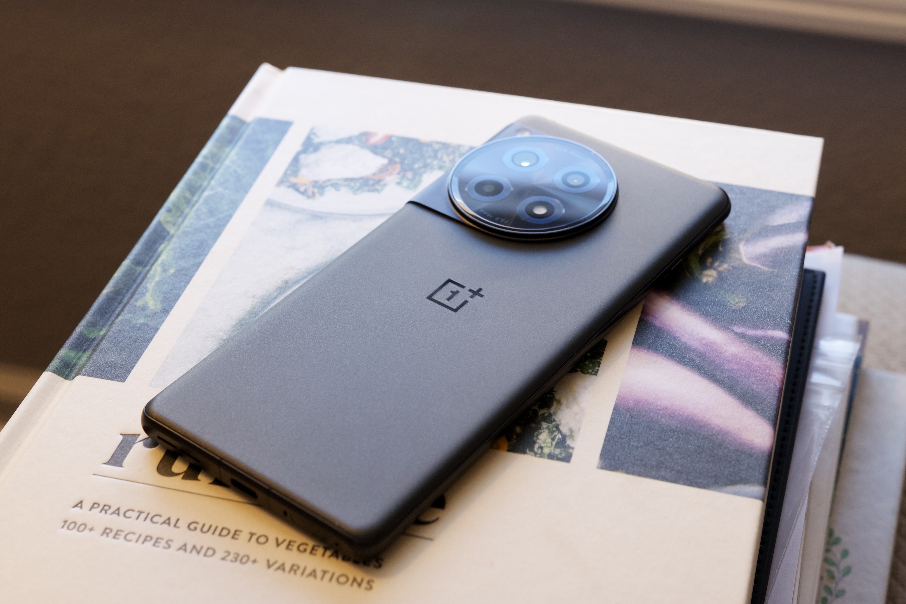 A photo of the OnePlus 12R lying on a book.