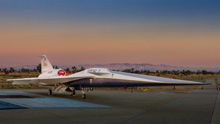 NASA’s X-59 quiet supersonic research aircraft sits on the apron outside Lockheed Martin’s Skunk Works facility at dawn in Palmdale, California. The X-59 is the centerpiece of NASA’s Quesst mission, which seeks to address one of the primary challenges to supersonic flight over land by making sonic booms quieter.