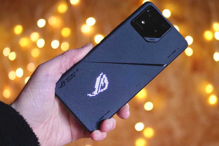 A person holding the Asus ROG Phone 8 Pro, showing the back.