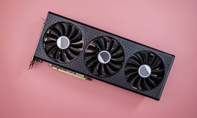 The RX 7600 XT graphics card on a pink background.