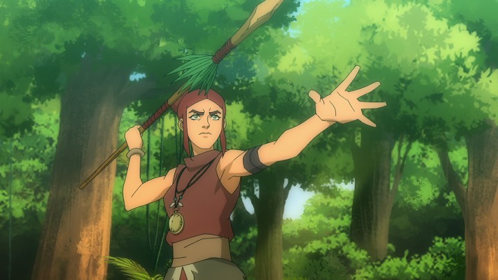 An animated image of a person holding a spear in the jungle in a scene from Skull Island.