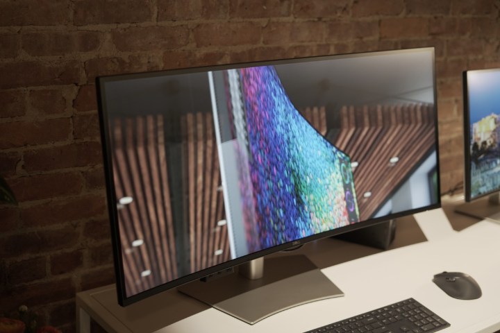 Two Dell UltraSharp monitors on display at an event.