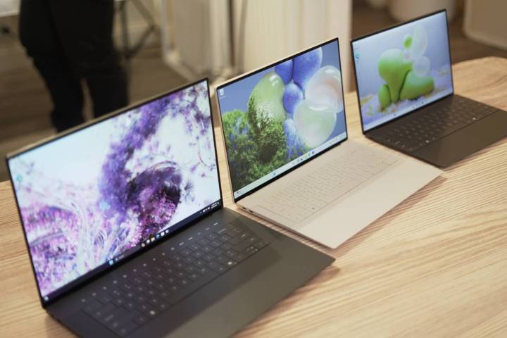 The XPS 16, XPS 14, and XPS 13 on a wooden table.