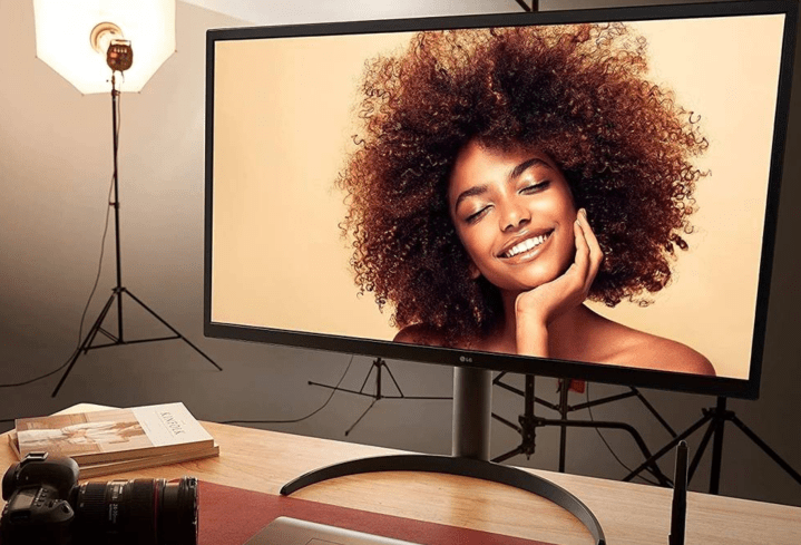 The 32-inch LG UltraFine 4K Monitor on a photographer's desk.