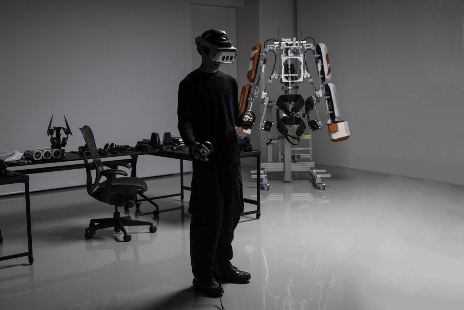 A Varjo X-4 VR headset is worn by a person standing in front of robotic exoskeleton.