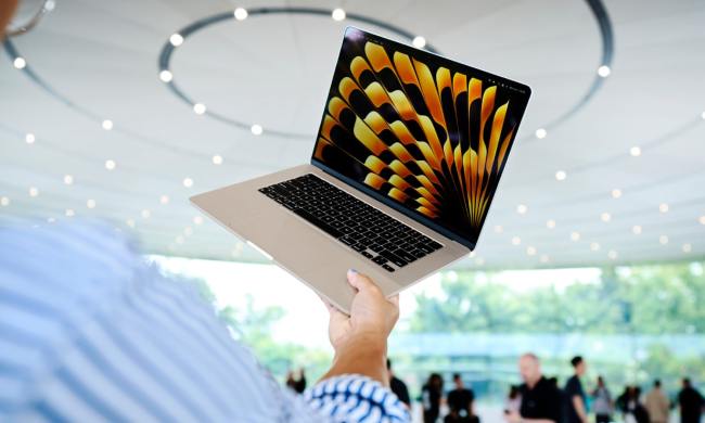 A person holds a MacBook Air at Apple's Worldwide Developer's Conference (WWDC) in 2023.