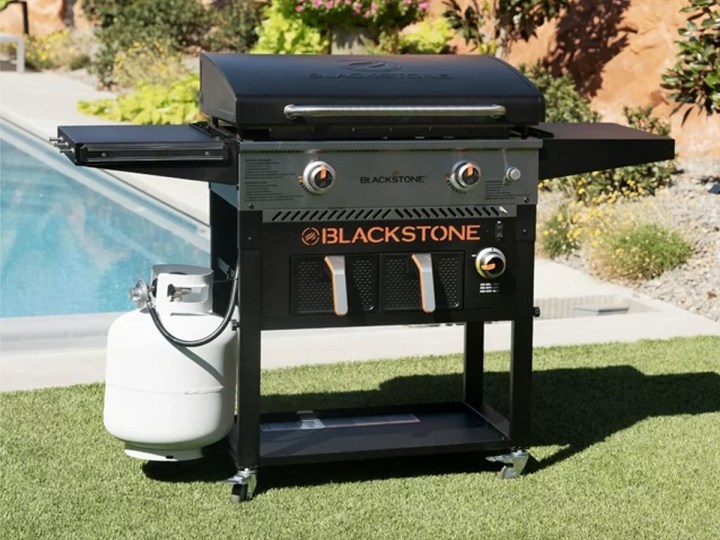 The Blackstone 28-inch propane griddle with air fryer in a yard.