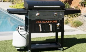 The Blackstone 28-inch propane griddle with air fryer in a yard.