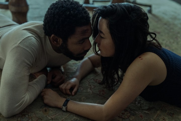 Donald Glover and Maya Erskine lie on the floor together in Mr. & Mrs. Smith.