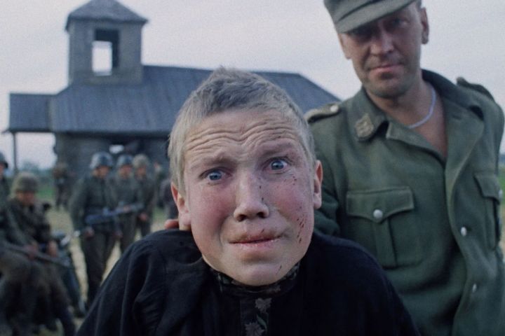 Florya (Aleksey Kravchenko) looking terrified as a soldier holds him by the neck in Come and See.