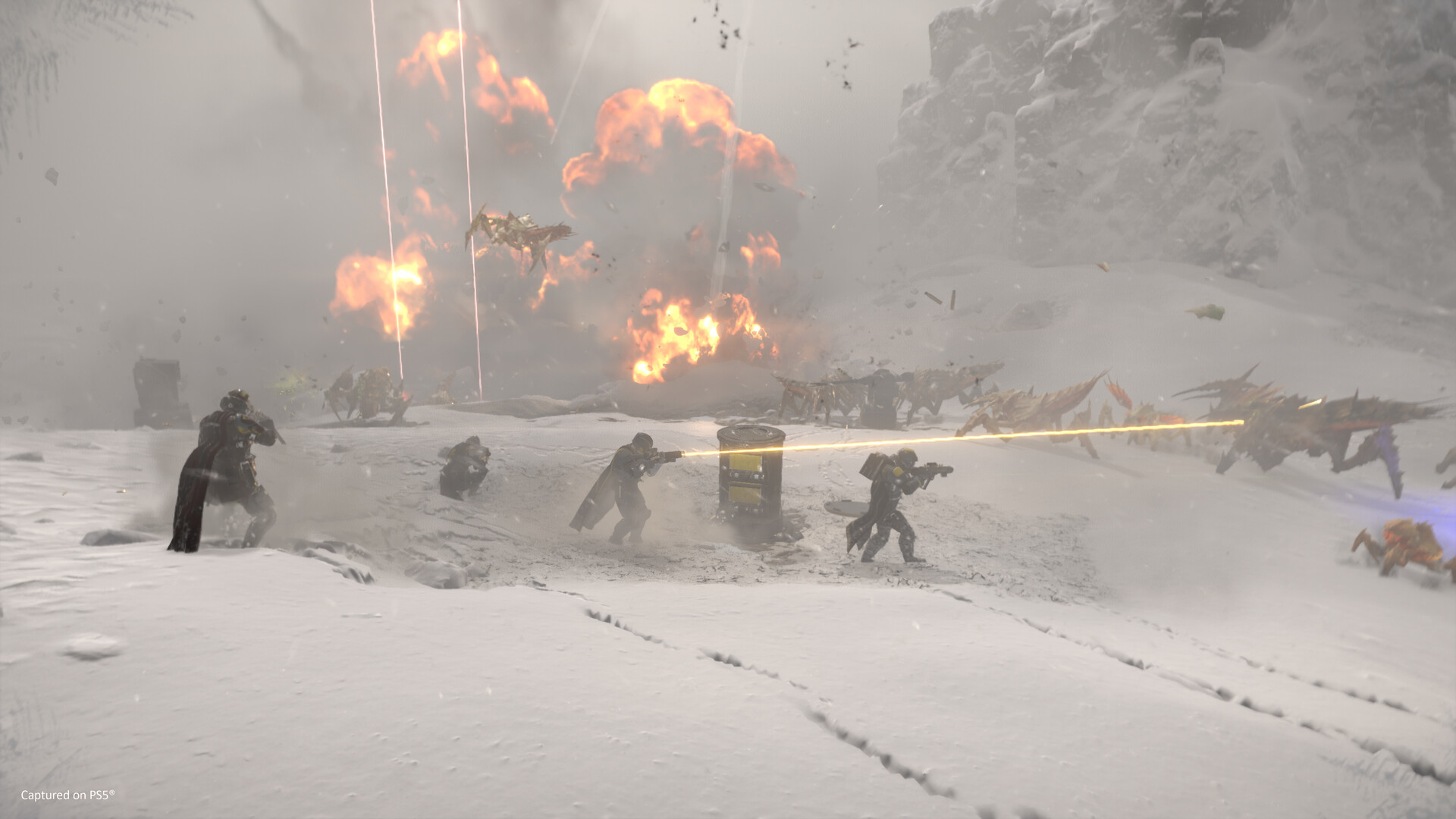 Four soldiers near an airstrike in Helldivers 2.