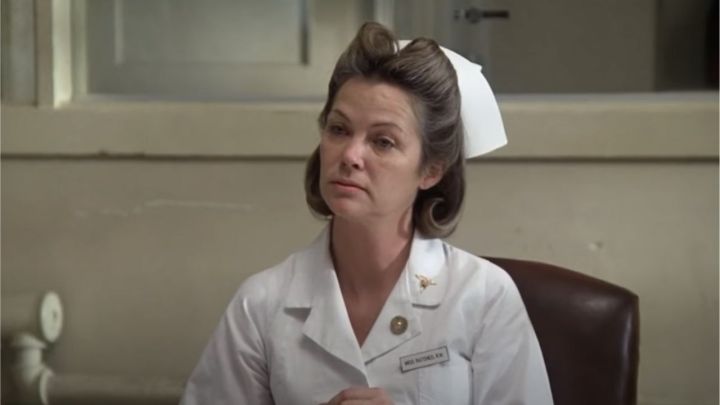 Louise Fletcher como la enfermera Ratched mirando fijamente a alguien en la película Alguien voló sobre el nido del cuco.