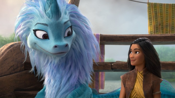 A still from Raya and the Last Dragon featuring the dragon Sisu and the the warrior princess Raya.