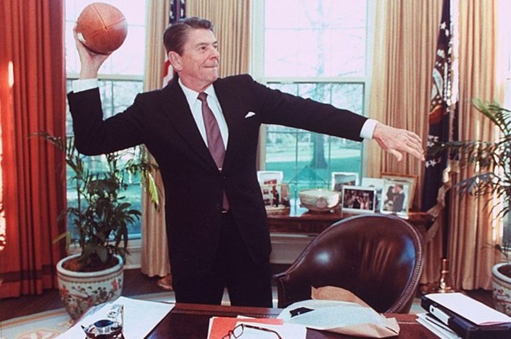Ronald Reagan throws a football in the Oval Office.