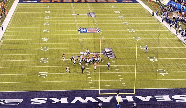 Players on a football field at the Super Bowl.