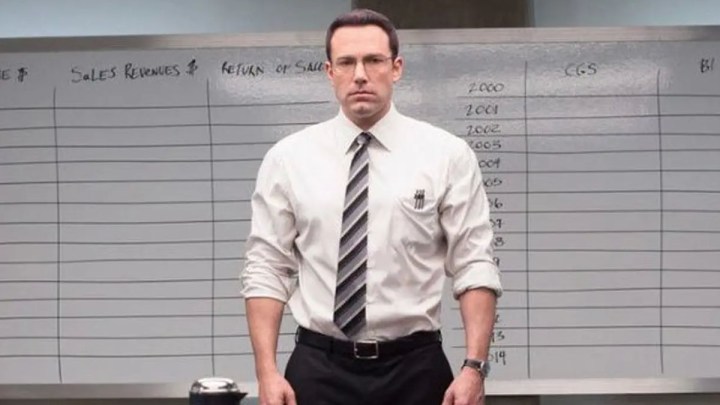 Ben Affleck stands in the room in front of a board in The Accountant.
