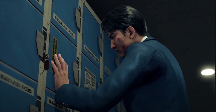 Ryo Aoki pressing his hand up to the blue coin lockers. his face is beaten and he is wearing a blue suit.