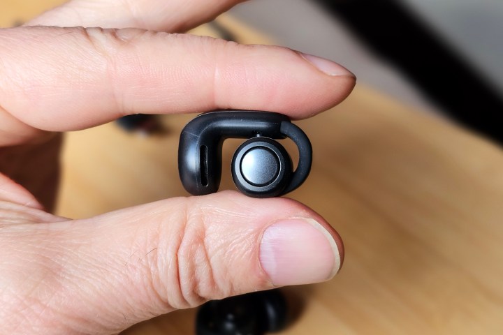 Bose Ultra Open Earbuds held by hand.