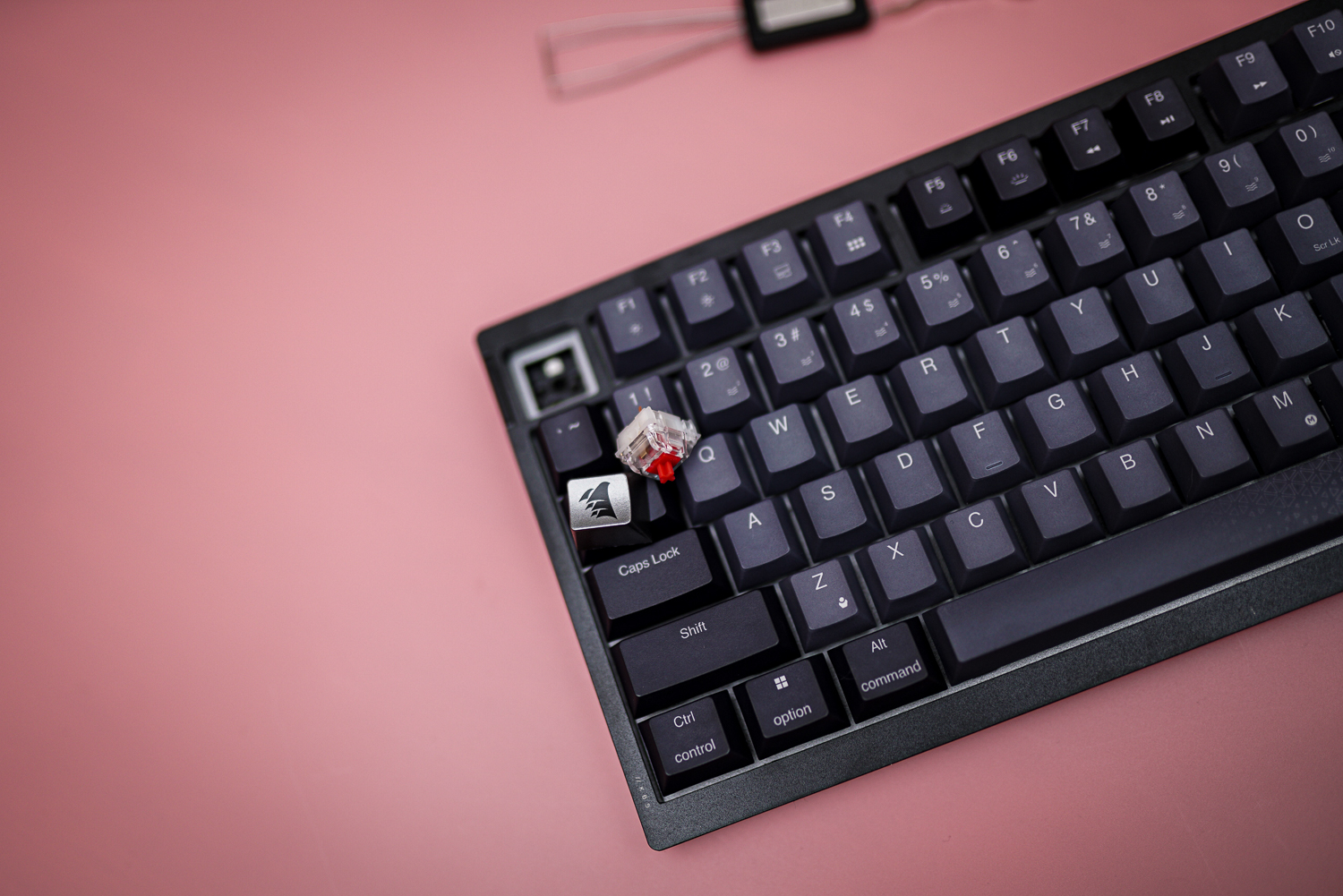 The Corsair K65 Plus with a key switch removed.