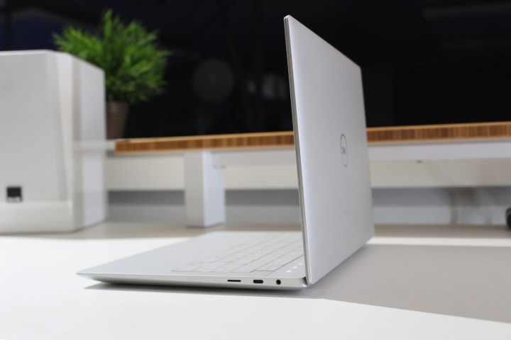 The side of the open Dell XPS 14 on a white table.