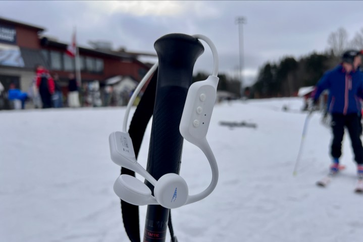 The HsO SnowPro headphones hanging on a ski pole.