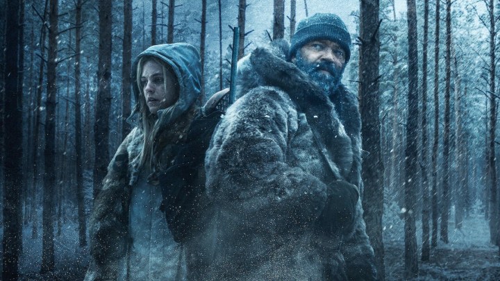 Two people stand in a forest in Hold the Dark.