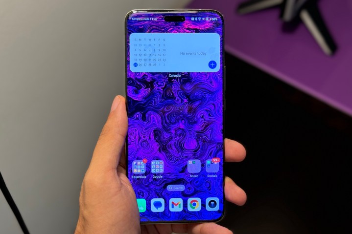 Someone holding the Honor Magic 6 Pro, showing the screen turned on.