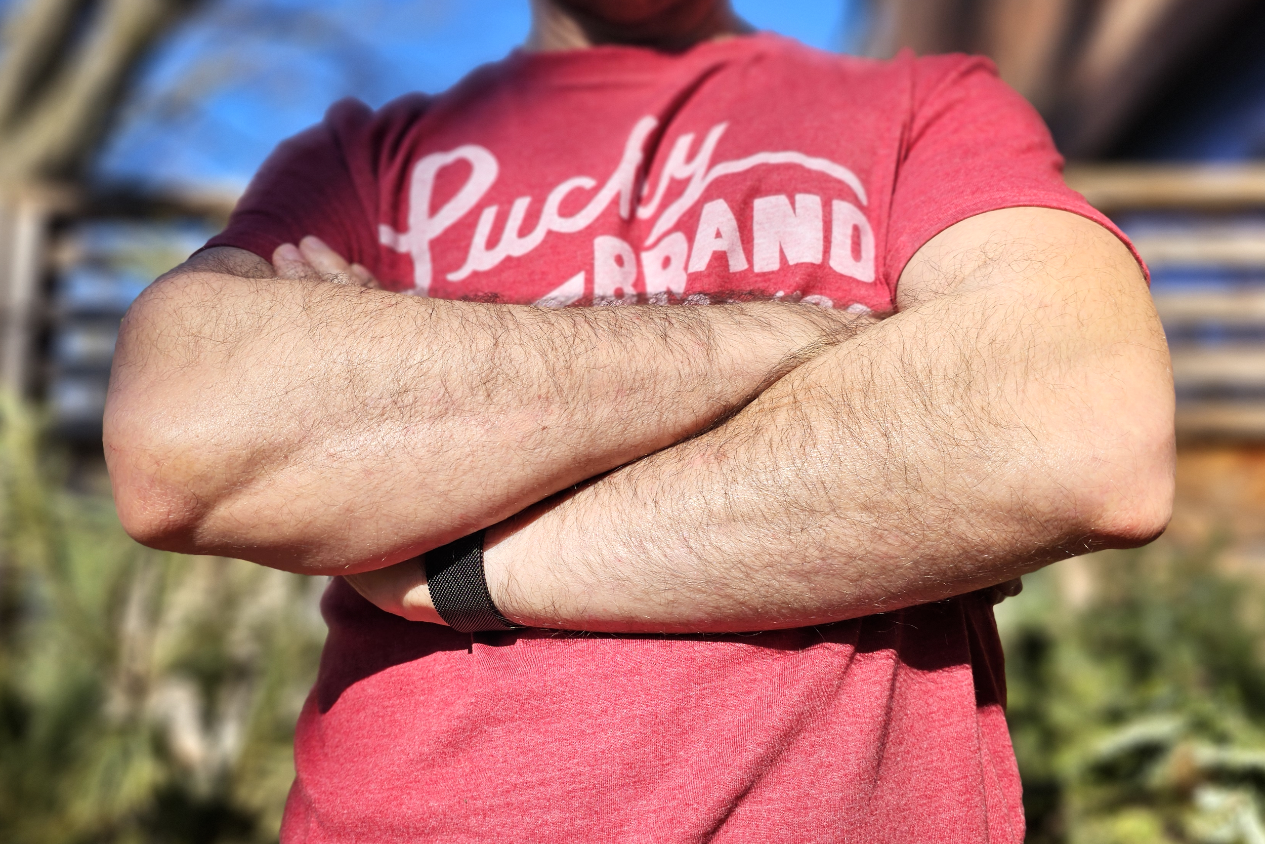 Simon Cohen wearing an Apple Watch while crossing his arms.