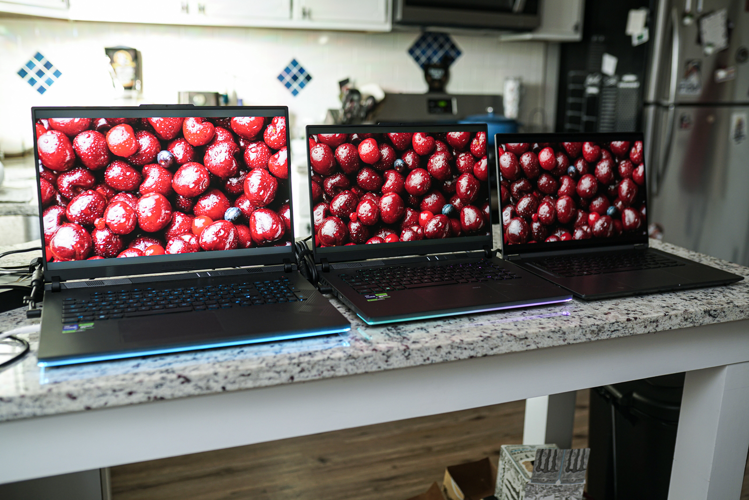 An HDR demo playing on three mini-LED laptops.