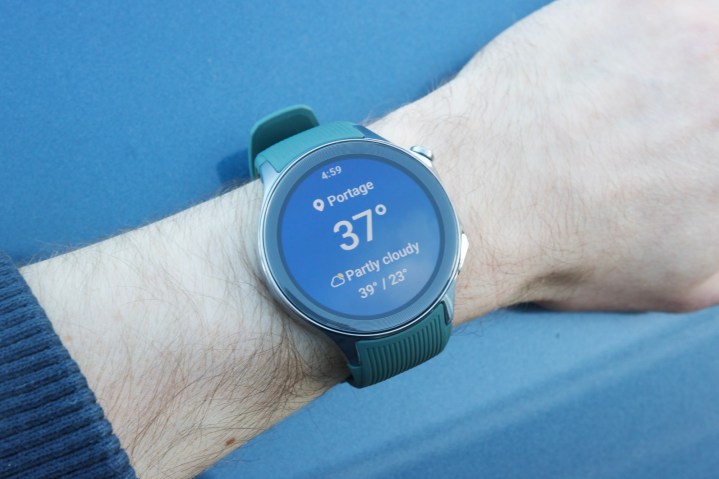 The OnePlus Watch 2 on someone's wrist, showing the weather app.