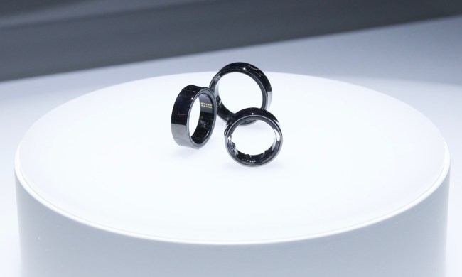 Three sizes of the Samsung Galaxy Ring, sitting on top of a white display case.