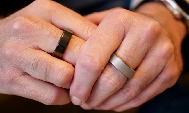 A person wearing the Oura Ring and the RingConn Smart Ring.