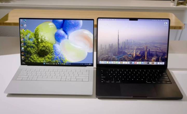The XPS 14 and MacBook Pro side by side on a desk.