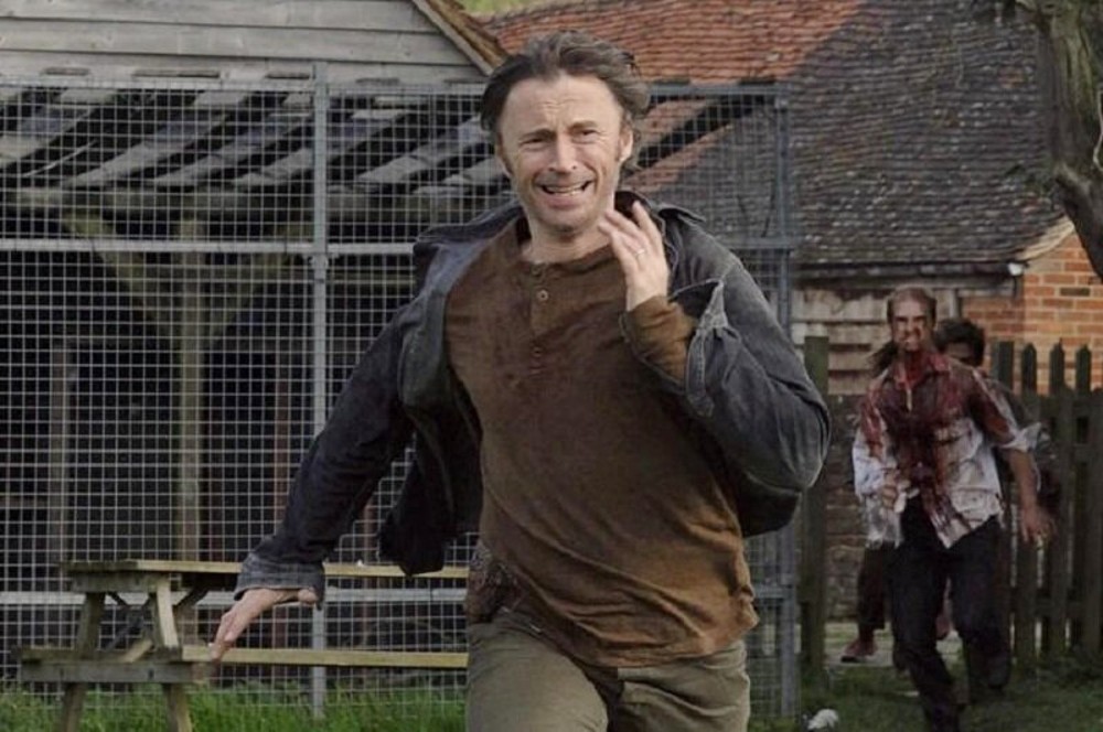 A man runs from zombies in 28 Weeks Later.
