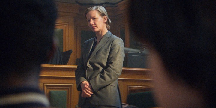 A woman bows her head in court in Anatomy of a Fall.