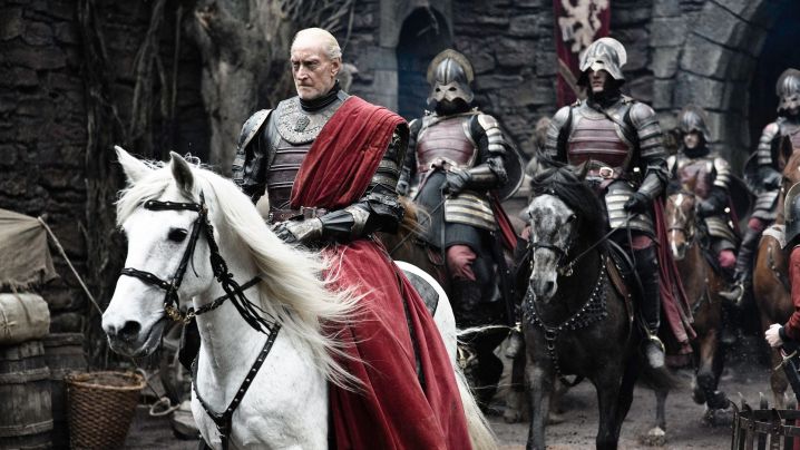 Charles Dance as Tywin Lannister riding a horse followed by a group of soldiers in Game of Thrones.