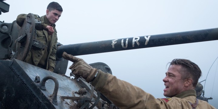A man points as another man sits in a tank in Fury.