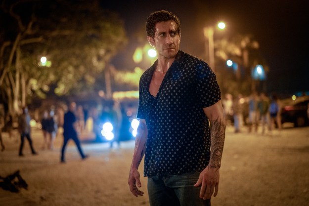 Jake Gyllenhaal stands in a parking lot in Road House.