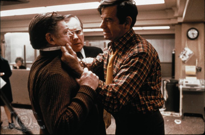 Walter Matthau as Lt Garber shakes some sense into his fellow transit authority worker in The Taking of Pelham 123