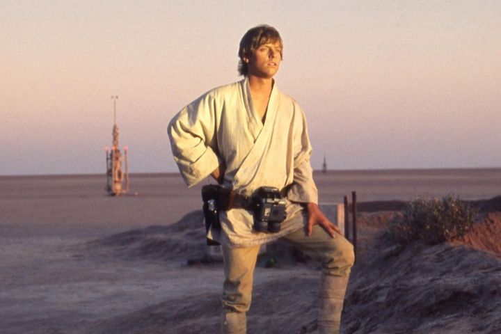 Luke looks at the sunset in Star Wars.